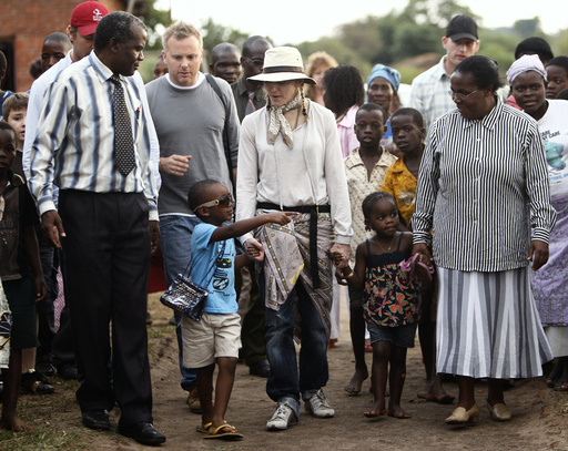 Madonna and her children David and Mercy visit the Mphandula Child Care Centre