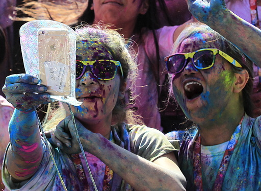 A runner takes a selfie photo while celebrating during a 
