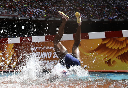 Rolanda Bell of Panama falling head first into the water obstacle during the women's 3000 metres steeplechase heats at the 15th IAAF World Championships in the National Stadium in Beijing