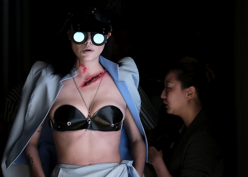 A model waits to present a creation by Chinese designer Hu Sheguang during China Fashion Week S/S 2016 in Beijing