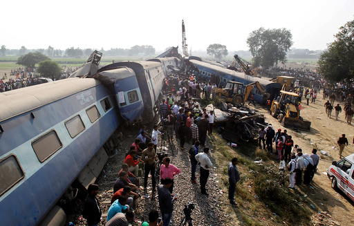 Rescue workers search for survivors at the site of a train derailment in Pukhrayan, south of Kanpur city, India