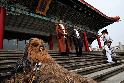Fans dressed as the characters from Star Wars react during Star Wars Day in Taipei