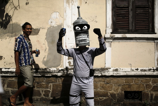 A reveller poses for a photo as he takes part in an annual block party known as Ceu na Terra , in Rio de Janeiro