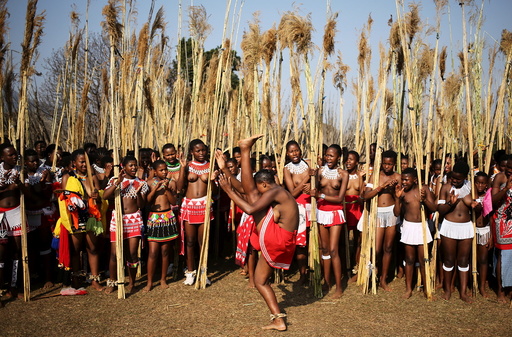A maiden takes her turn to dance as others watch while preparing to deliver the reeds at Ludzidzini royal palace during the annual Reed Dance in Swaziland