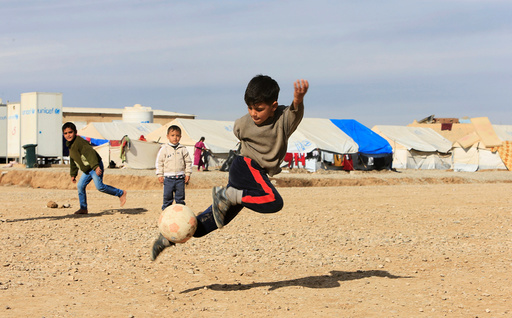 Displaced Iraqi children, who fled the Islamic State stronghold of Mosul, play at Khazer camp