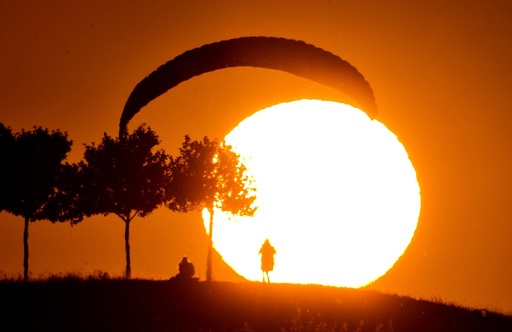 A Paraglider lands at sunset