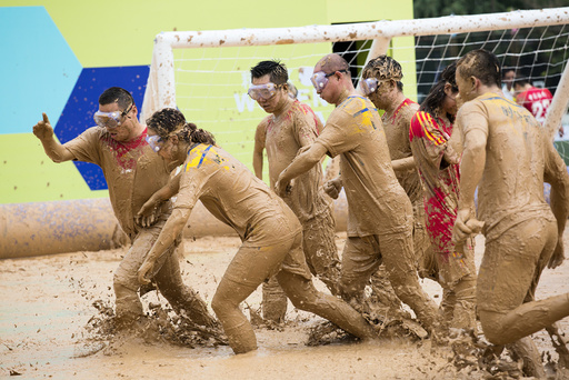 People play during their match at a swamp soccer tournament in Beijing, China