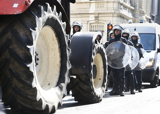Riot police face off with farmers during a demonstration near the EU headquarters Brussels