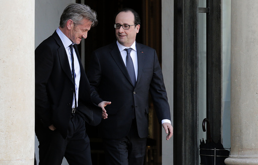 French President Hollande talks with actor Penn after a meeting at the Elysee Palace in Paris