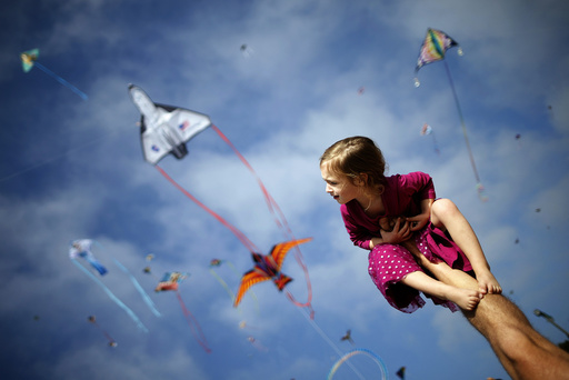 Klonoski sits on her father's leg at a kite festival in Redondo Beach