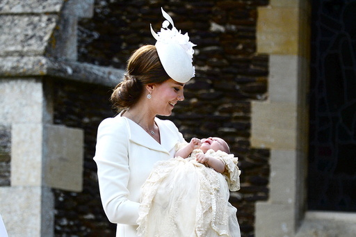 Norfolk, England, July 5th: The Duchess of Cambridge carries her daughter Princess Charlotte into the Church of St Mary Magdalene on the Sandringham Estate for the princess's christening, on July 5th 2015. The Duchess and her daughter were accompanie