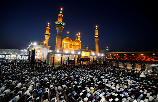Shi'ite pilgrims pray at the Shrine of Imam Moussa al-Kadhim in Baghdad