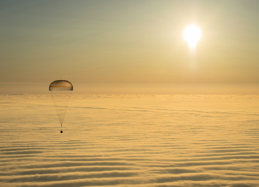 The Soyuz TMA-14M capsule with ISS crew members Barry Wilmore of the U.S., Alexander Samokutyaev and Elena Serova of Russia is seen above clouds as it descends before landing southeast of Dzhezkazgan