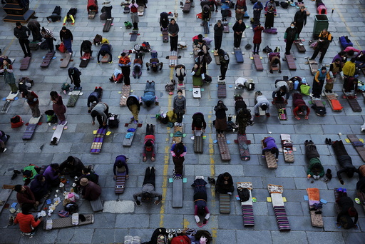 Pilgrims pray outside the Jokhang Temple in central Lhasa, Tibet Autonomous Region, China, at dawn