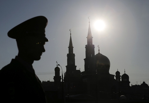 An Interior Ministry member stands guard near the Moscow Grand Mosque before an opening ceremony in Moscow
