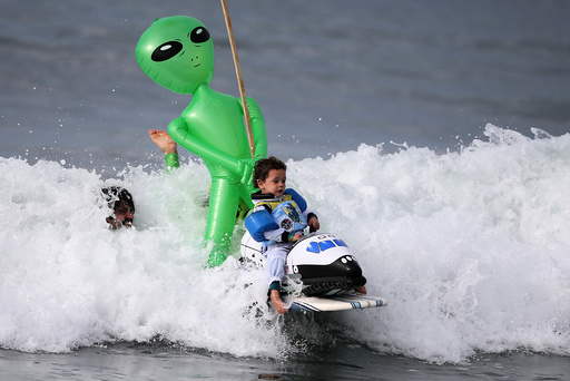 Oliver Quiros, 3, competes dressed as an astronaut in a space shuttle in the Haunted Heats Halloween Surf Contest in Santa Monica