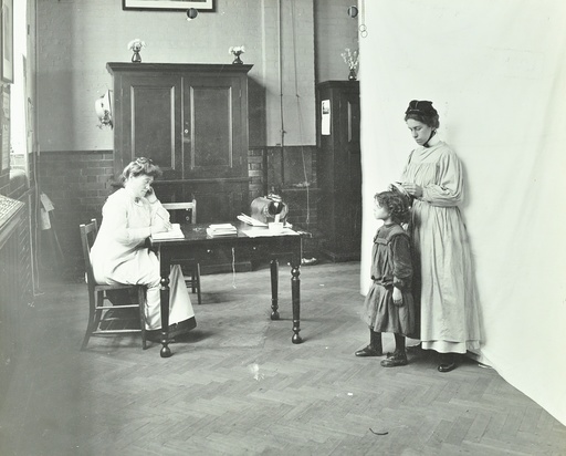 School nurse examining girls' hair for head lice, Chaucer School, London, 1911. Artist: Unknown.
