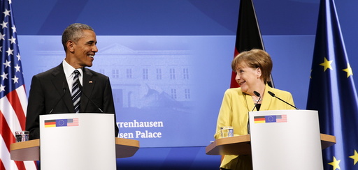U.S. President Barack Obama and German Chancellor Angela Merkel smile at one another during a news conference at Schloss Herrenhausen in Hanover