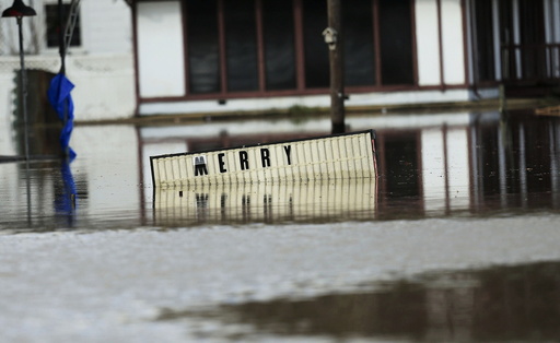 A sign sits underwater located in the downtown area of Elba