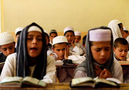 Afghan boys read the Koran in a madrasa, or religious school, during the Muslim holy month of Ramadan in Kabul