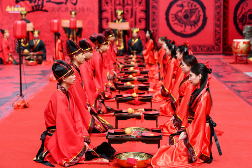 Couples attend a group wedding ceremony in traditional Han Dynasty style as they celebrate Qixi festival, or Chinese Valentine's Day, in Hengyang