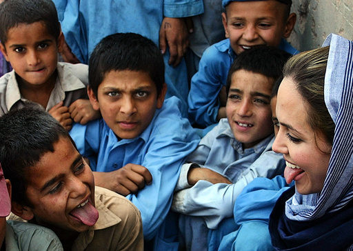 Hollywood actress and Oscar winner, Angelina Jolie, plays with Afghan refugee children during her ...