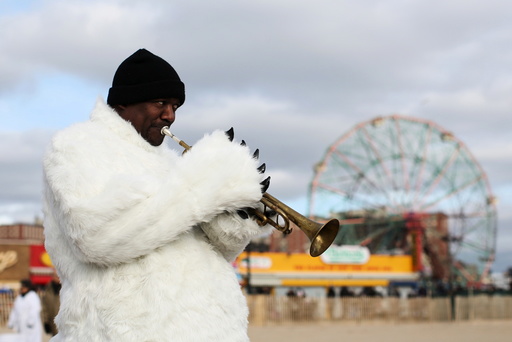 A man in a polar bear costume plays a trumpet before the Coney Island Polar Bear Club's annual New Year's Day swim at Coney Island in the Brooklyn borough of New York.