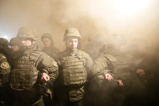 Law enforcement officers stand guard during a gathering to mark the Ukrainian Military Volunteer Day in Kiev