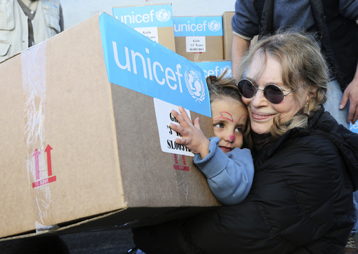U.S. actress Mia Farrow, a UNICEF goodwill ambassador, distributes aid to Syrian refugee children in Baalbeck, Bekaa valley