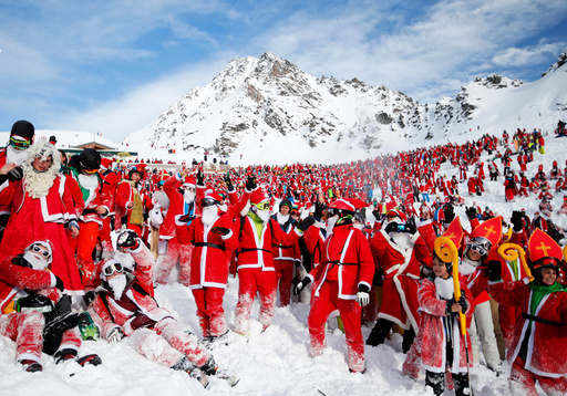 People dressed as Santa Claus enjoy the snow during the Saint Nicholas Day at the Alpine ski resort of Verbier