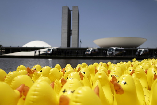 Inflatable dolls in the shape of ducks are seen in front of the National Congress during a protest against tax increases in Brasilia