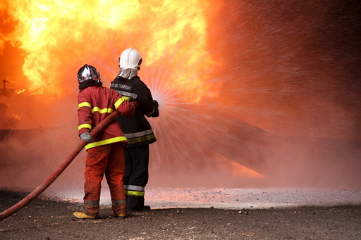 Firefighters try to put out the fire in an oil tank in the port of Es Sider, in Ras Lanuf