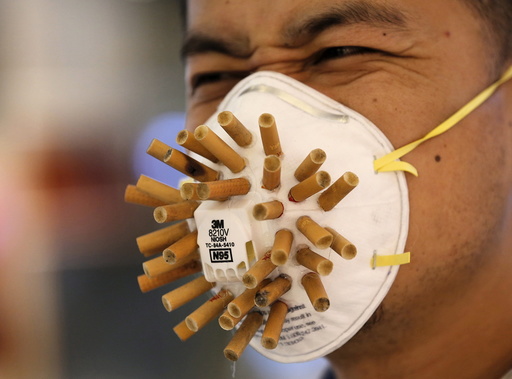 Man wears a mask decorated with cigarette butts, designed by Chinese designer Wen Fang at Wen's 