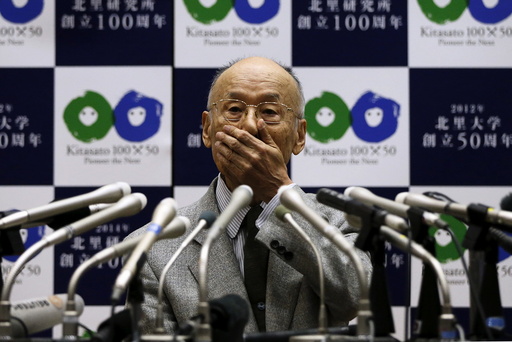 Omura, special honour professor of Kitasato University, reacts as he attends a news conference in Tokyo