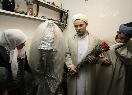 Russian citizen Abdul Rakhim and his bride Nasebakhon stand with witnesses at a wedding in Dushanbe