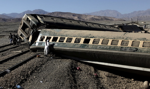 A passenger looks for his belongings after a train derailed in Quetta