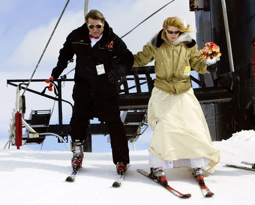 Bride and groom get off ski lift head for mountaintop wedding