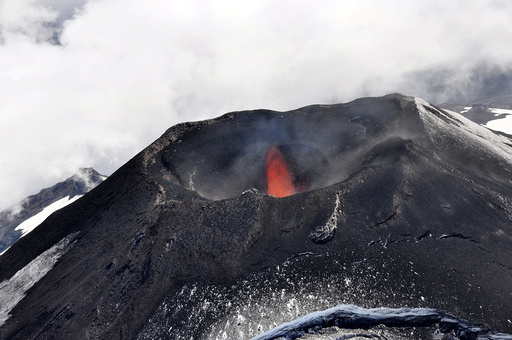 An aerial view shows smoke and lava spewing from the Villarrica volcano south of Santiago