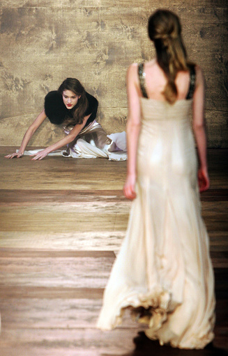 A model falls as she wears a creation by Amanda Wakeley at her show during London Fashion Week