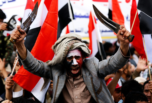 Man waves traditional daggers, or Jambiyas, as he attends with supporters of the Houthi movement and Yemen's former president Ali Abdullah Saleh a rally to mark two years of the military intervention by the Saudi-led coalition, in Sanaa, Yemen
