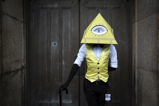 Louscher dressed as Bill Cipher from Gravity Falls poses as he attends Day Two of New York Comic Con in Manhattan