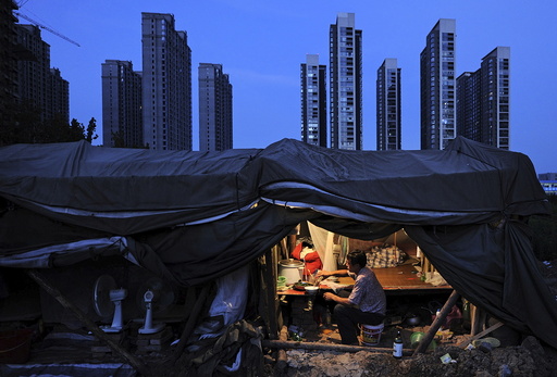 File photo of a labourer having his dinner under his shed at a construction site of a residential complex in Hefei