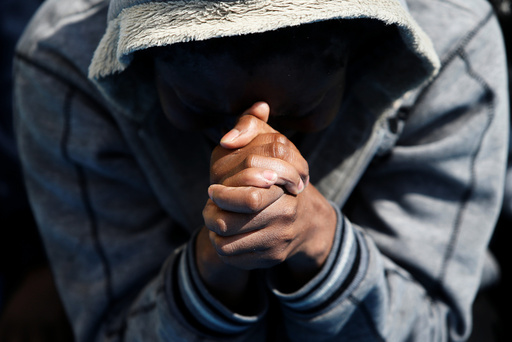 A migrant prays on the Migrant Offshore Aid Station ship Topaz Responder after being rescued around 20 nautical miles off the coast of Libya