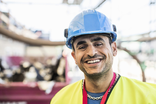 Portrait of happy construction worker at site