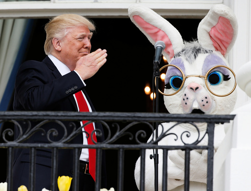 U.S. President Trump salutes a member of the military who had sung the national anthem as he stands with Easter Bunny character at White House Easter Egg Roll in Washington