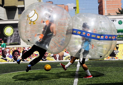 People take part in a game of 'bubble bump soccer' during an exhibition tournament in Medellin, Colombia