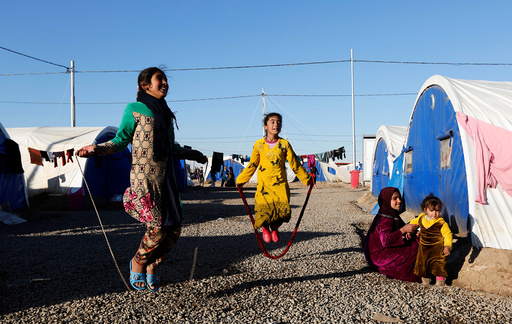Displaced Iraqi girls who fled the Islamic State stronghold of Mosul, play at Khazer camp