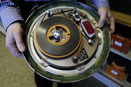 An employee of Germany's Bundesamt fuer Fluguntersuchung BFU (German Federal Bureau of Aircraft Accident Investigation) holds a Russian-made historic tape-based voice recorder at their headquarters in Braunschweig