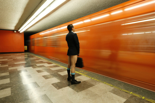 A passenger without pants waits for the subway train during 
