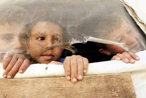 Syrian refugee children look out from their tent during a visit by U.N. Humanitarian Chief and Emergency Relief Coordinator O'Brien to their makeshift settlement in Saadnayel in Lebanon's Bekaa Valley